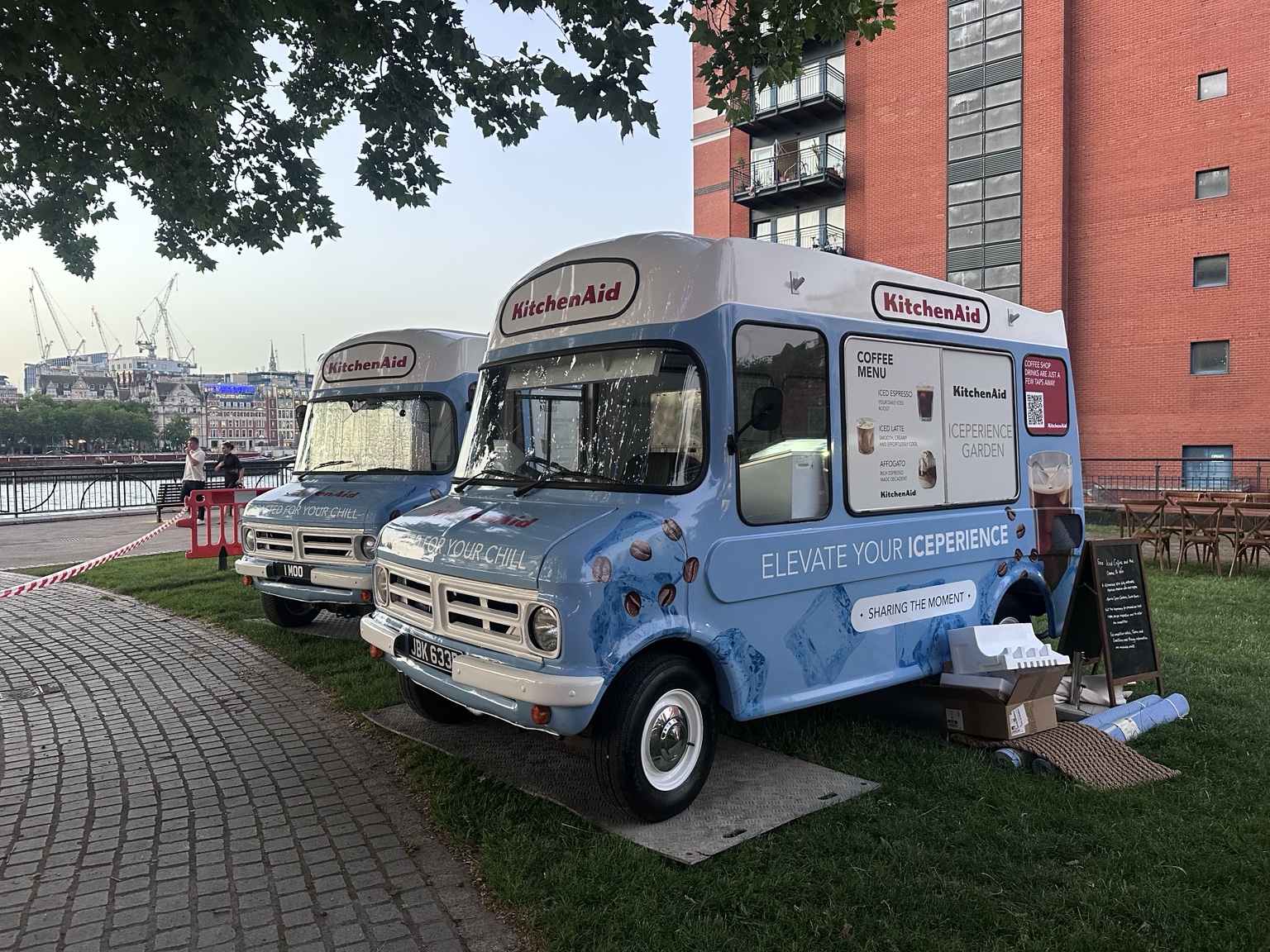 Two wrapped Bedford CF vans at a riverside corporate event