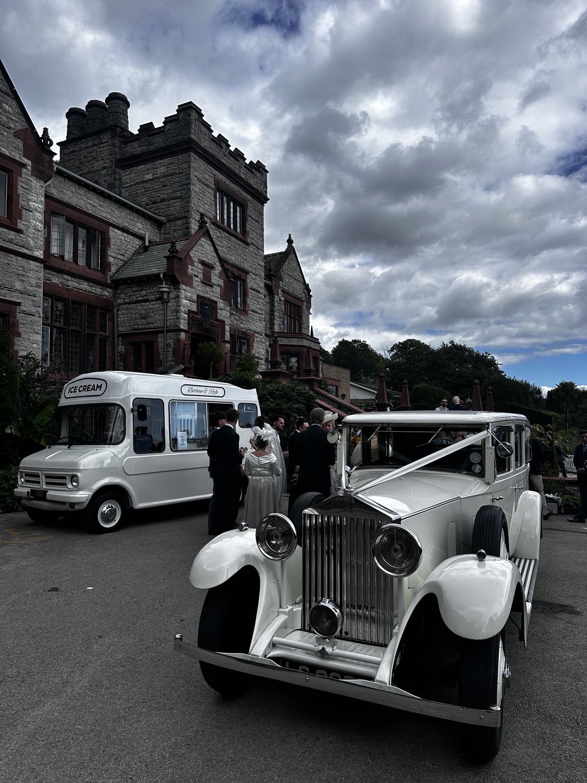 William serving at a wedding beside a classic wedding car